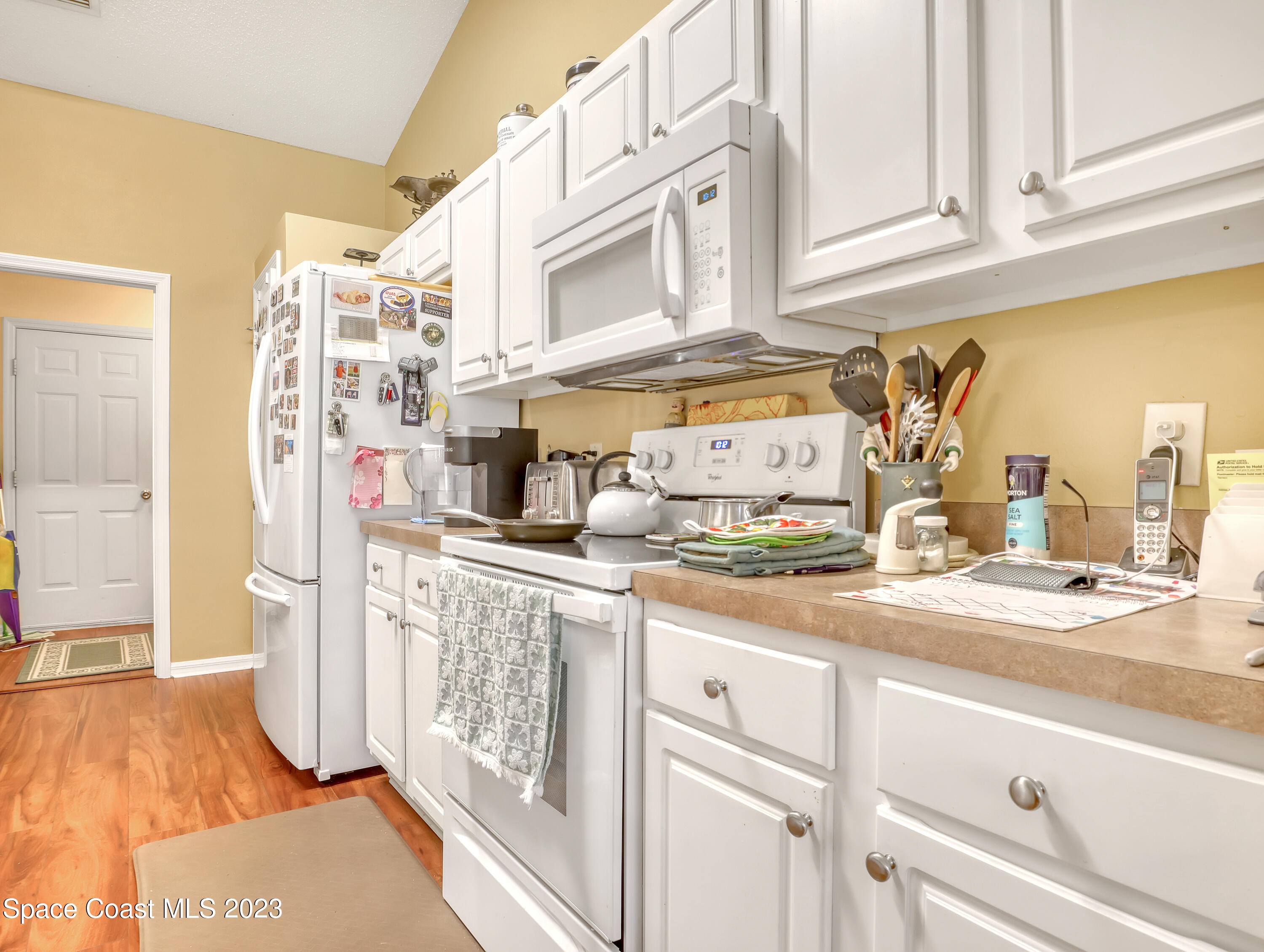 1550 Reed Street Northwest Palm Bay, FL 32907 - Photo 12 of 33 a kitchen with stainless steel appliances granite countertop a sink and cabinets