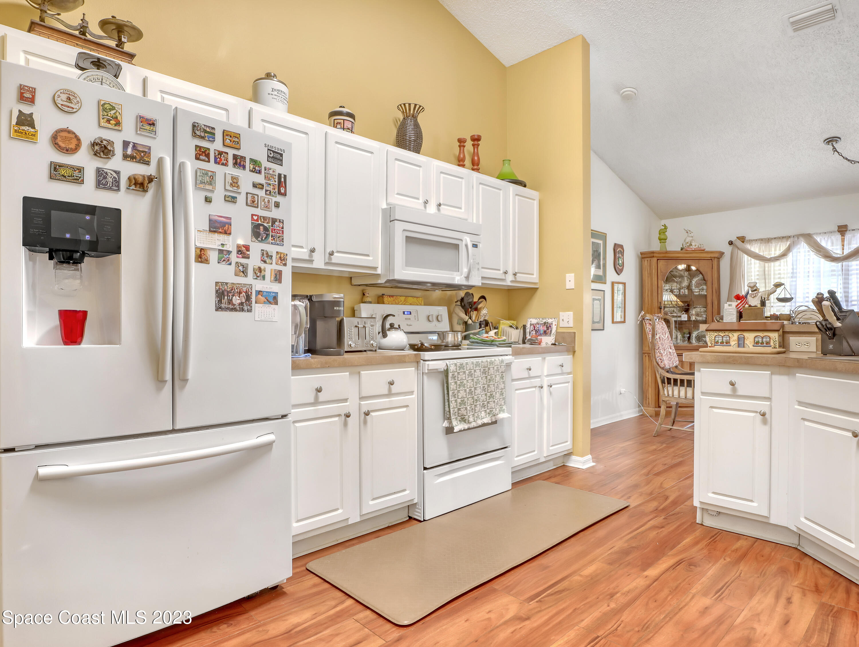 1550 Reed Street Northwest Palm Bay, FL 32907 - Photo 13 of 33 a kitchen with cabinets and wooden floor