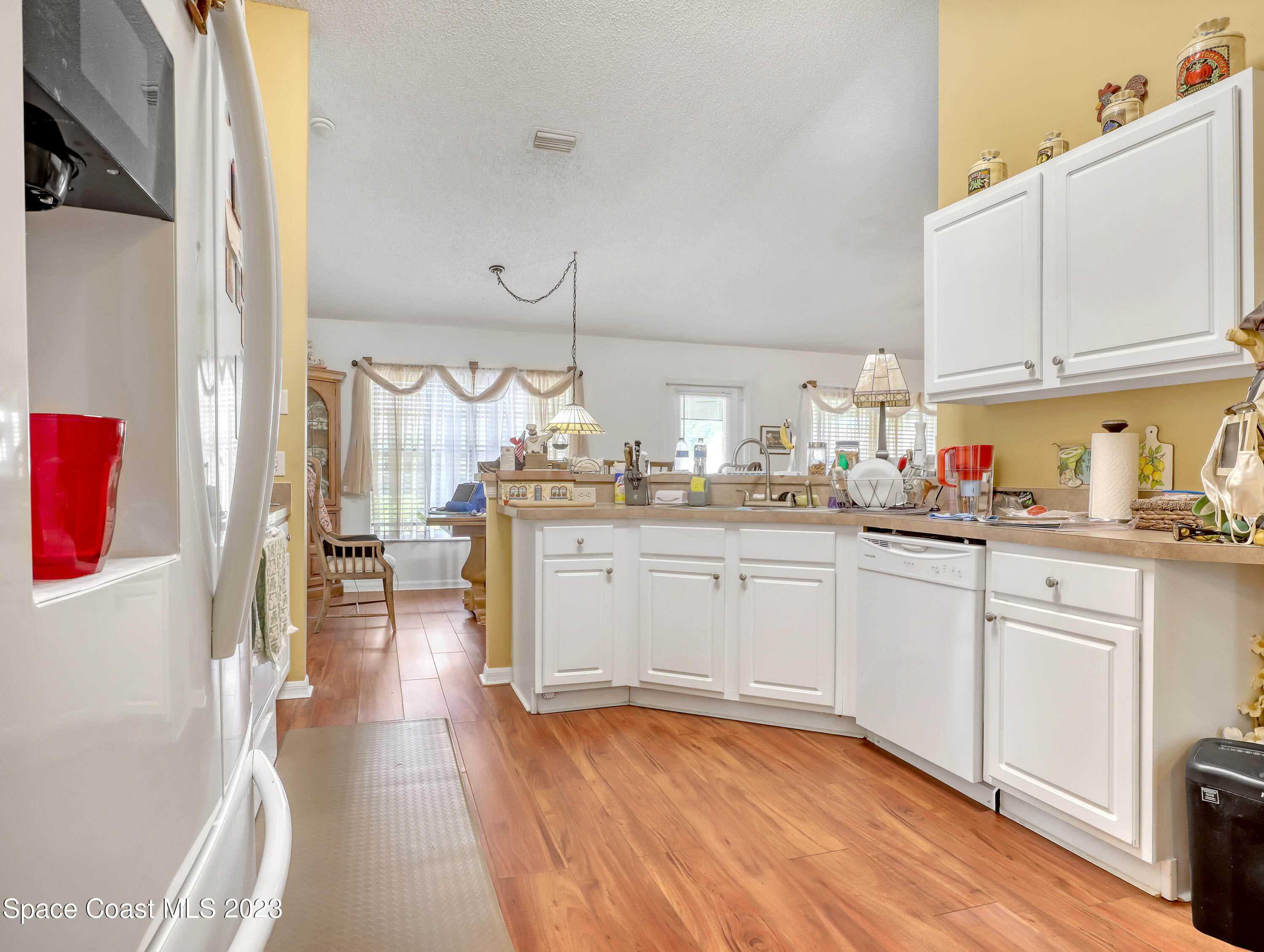 1550 Reed Street Northwest Palm Bay, FL 32907 - Photo 14 of 33 a kitchen with cabinets and wooden floor