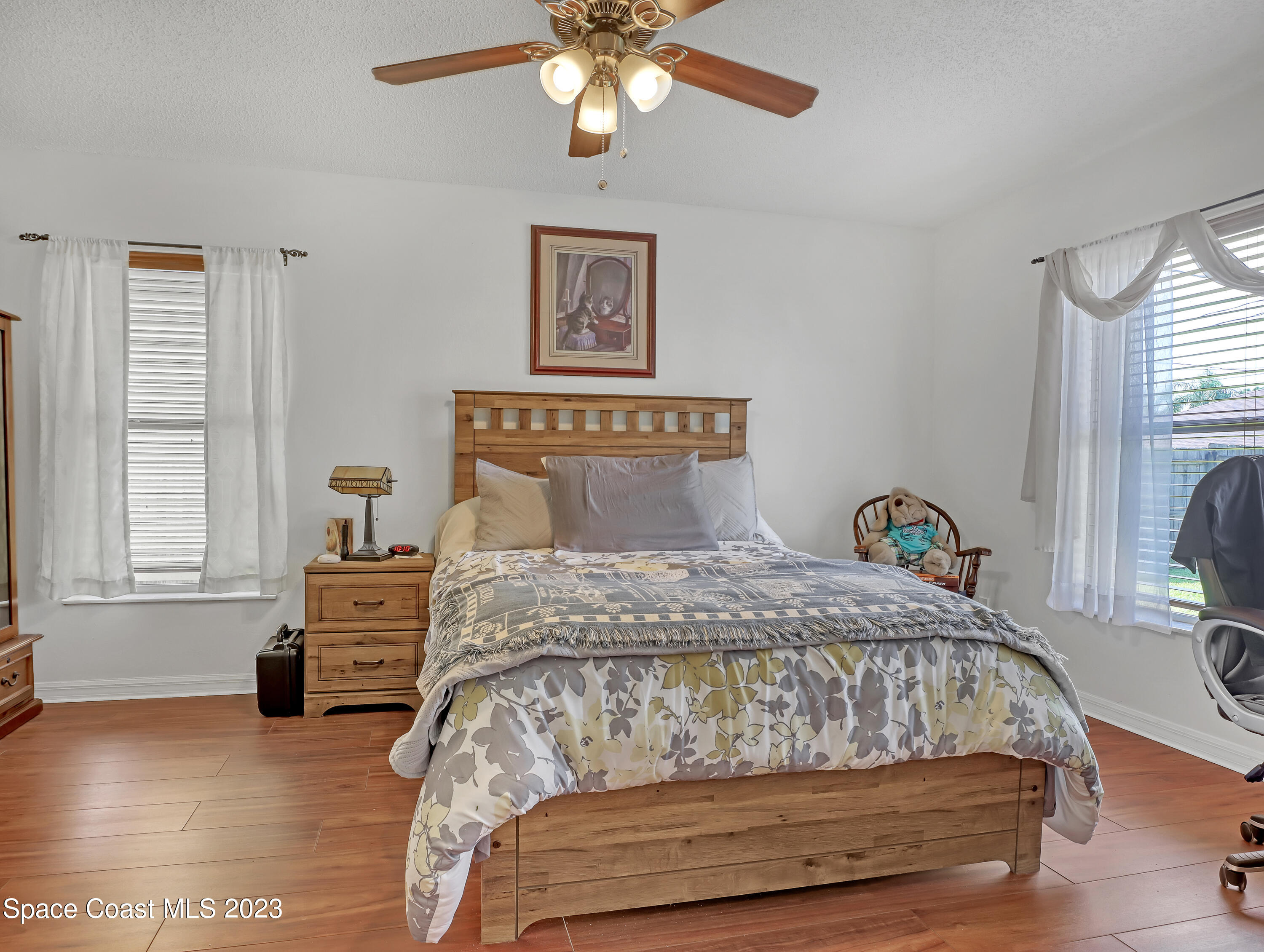 1550 Reed Street Northwest Palm Bay, FL 32907 - Photo 17 of 33 a bedroom with a bed chandelier and a window