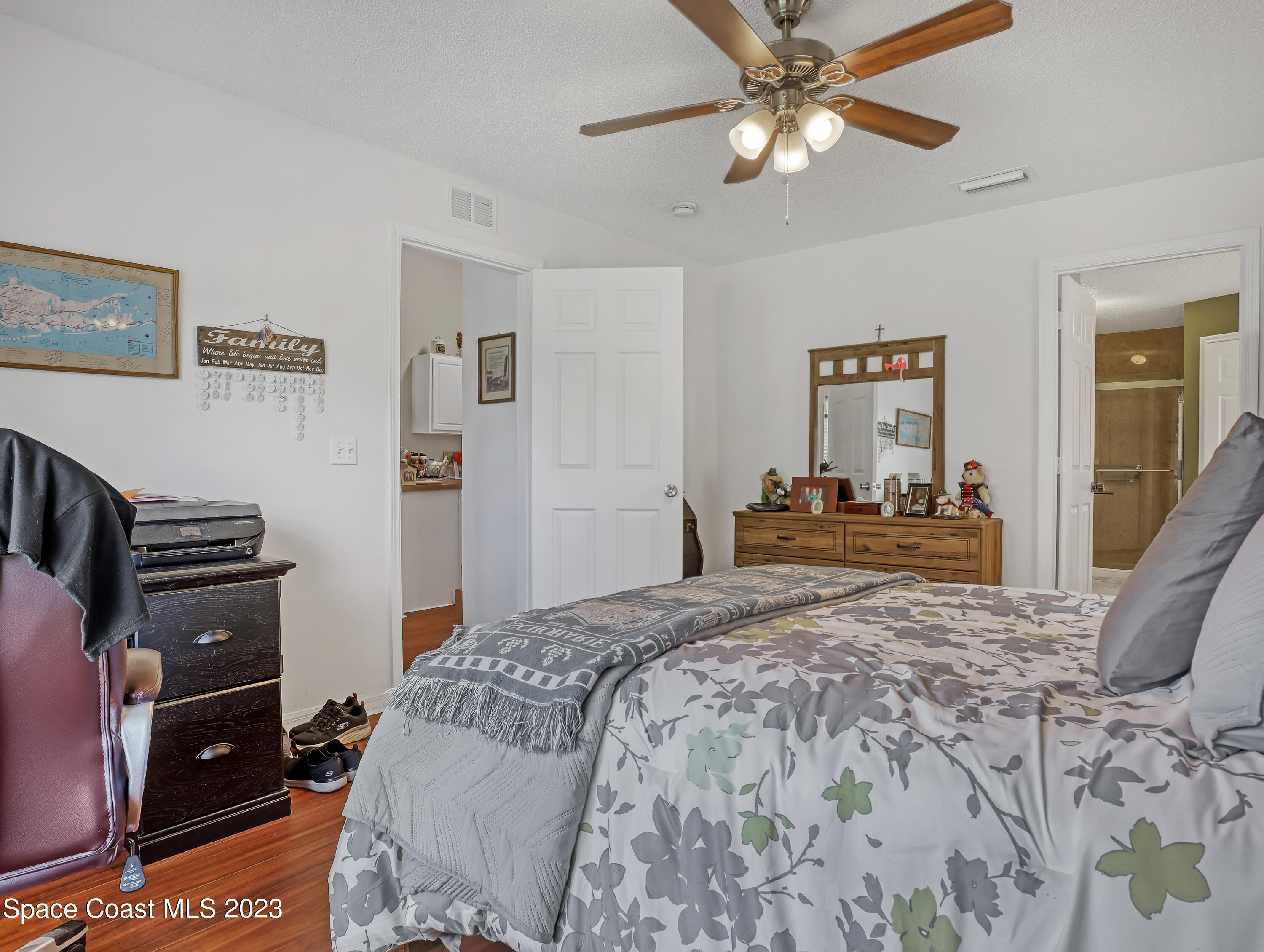 1550 Reed Street Northwest Palm Bay, FL 32907 - Photo 18 of 33 a bed room with a bed and a chandelier
