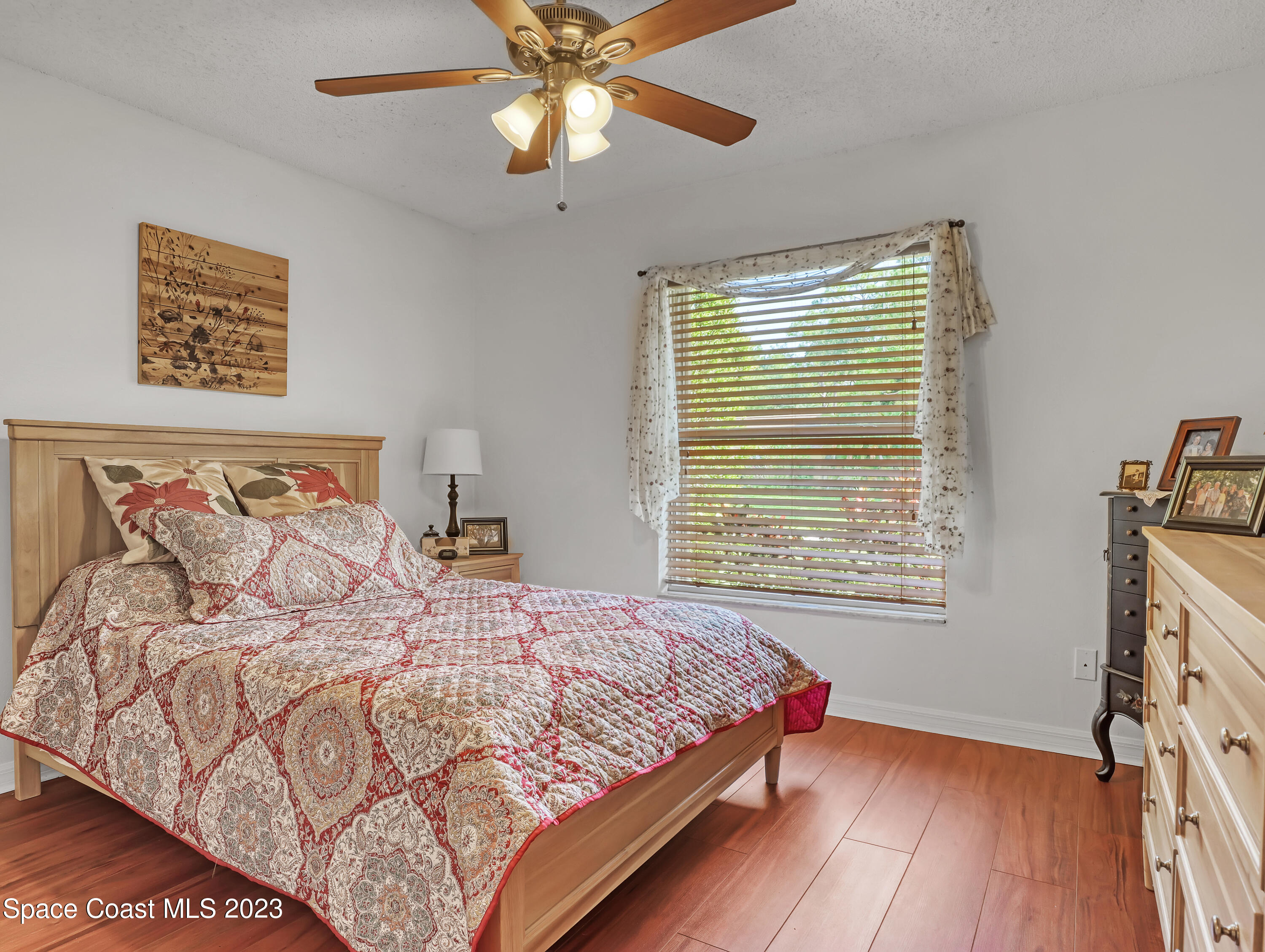 1550 Reed Street Northwest Palm Bay, FL 32907 - Photo 21 of 33 a bedroom with a large bed and a chandelier