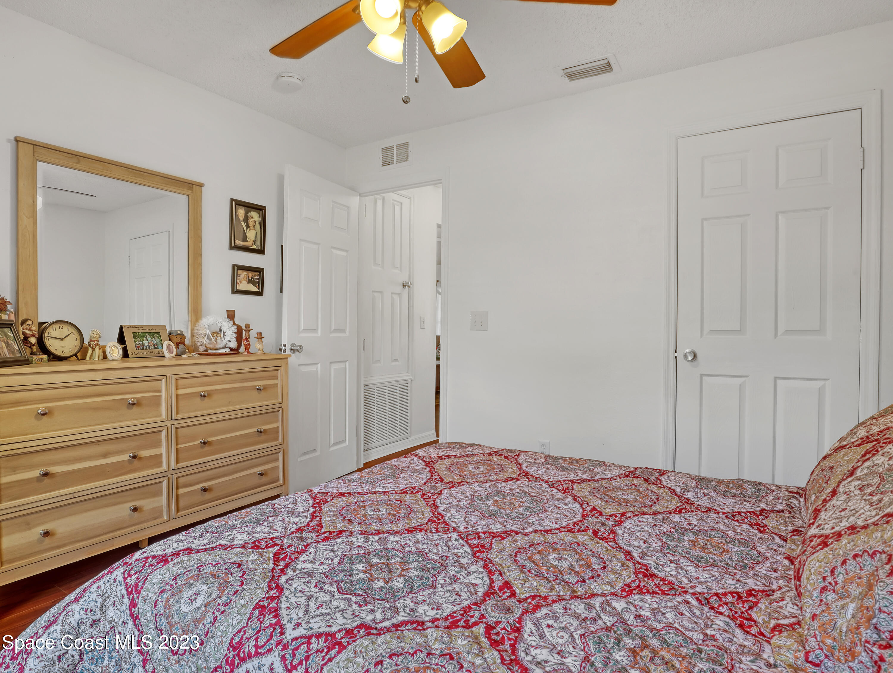 1550 Reed Street Northwest Palm Bay, FL 32907 - Photo 22 of 33 a bedroom with a bed and a dresser in it