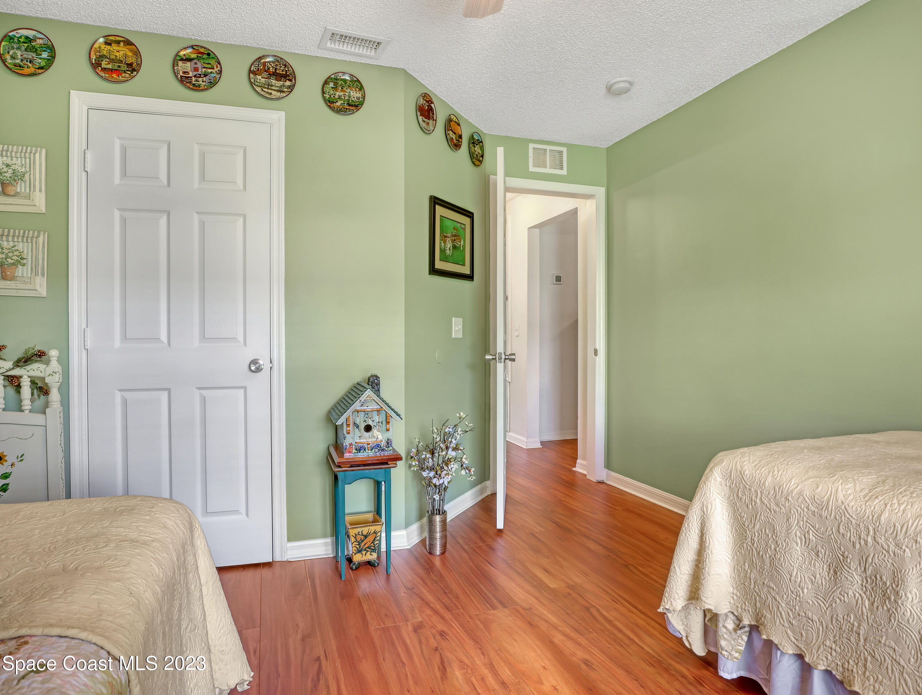 1550 Reed Street Northwest Palm Bay, FL 32907 - Photo 25 of 33 a bedroom with a bed and a wooden floor