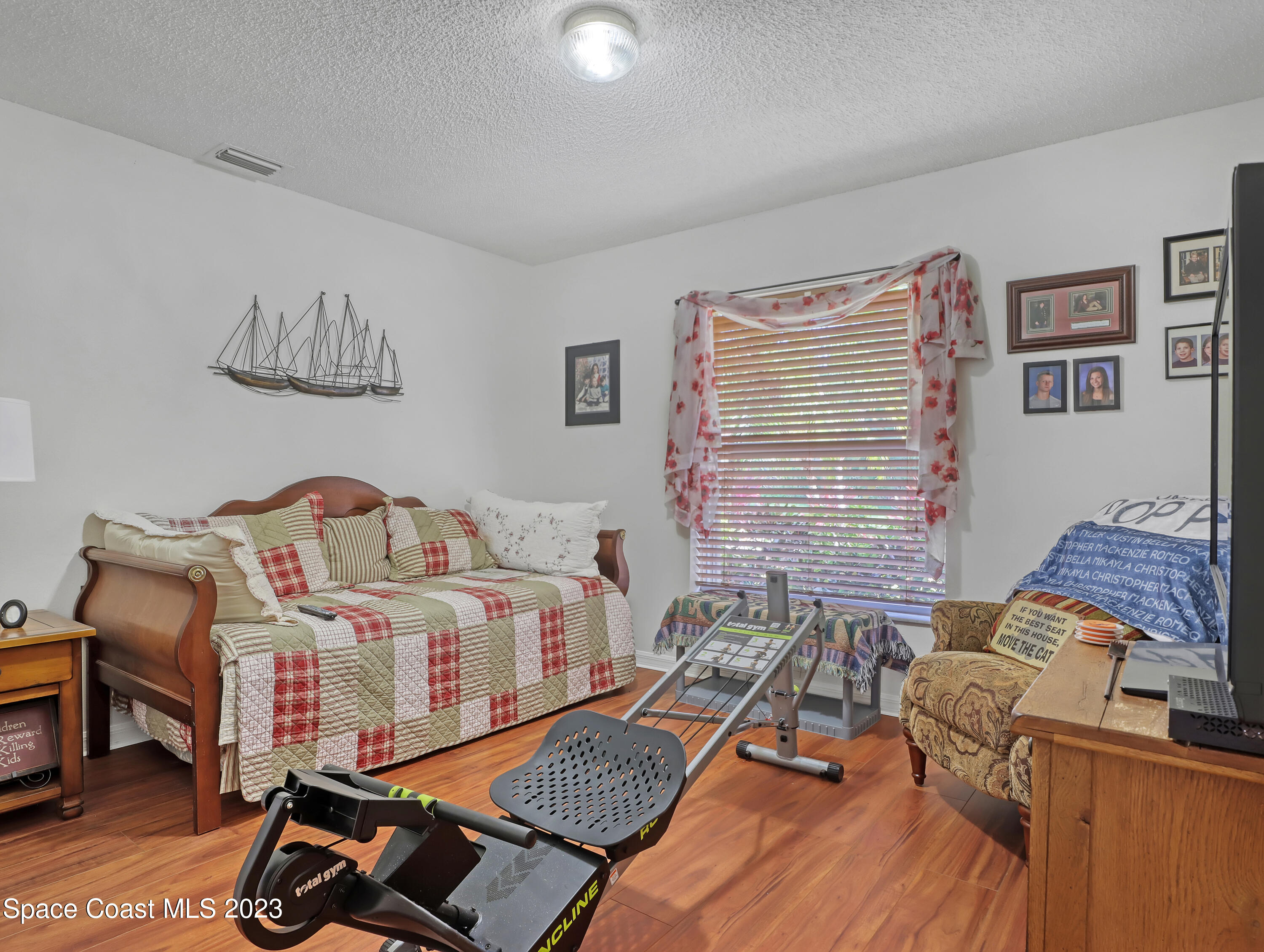 1550 Reed Street Northwest Palm Bay, FL 32907 - Photo 26 of 33 a bedroom with furniture and a wooden floor