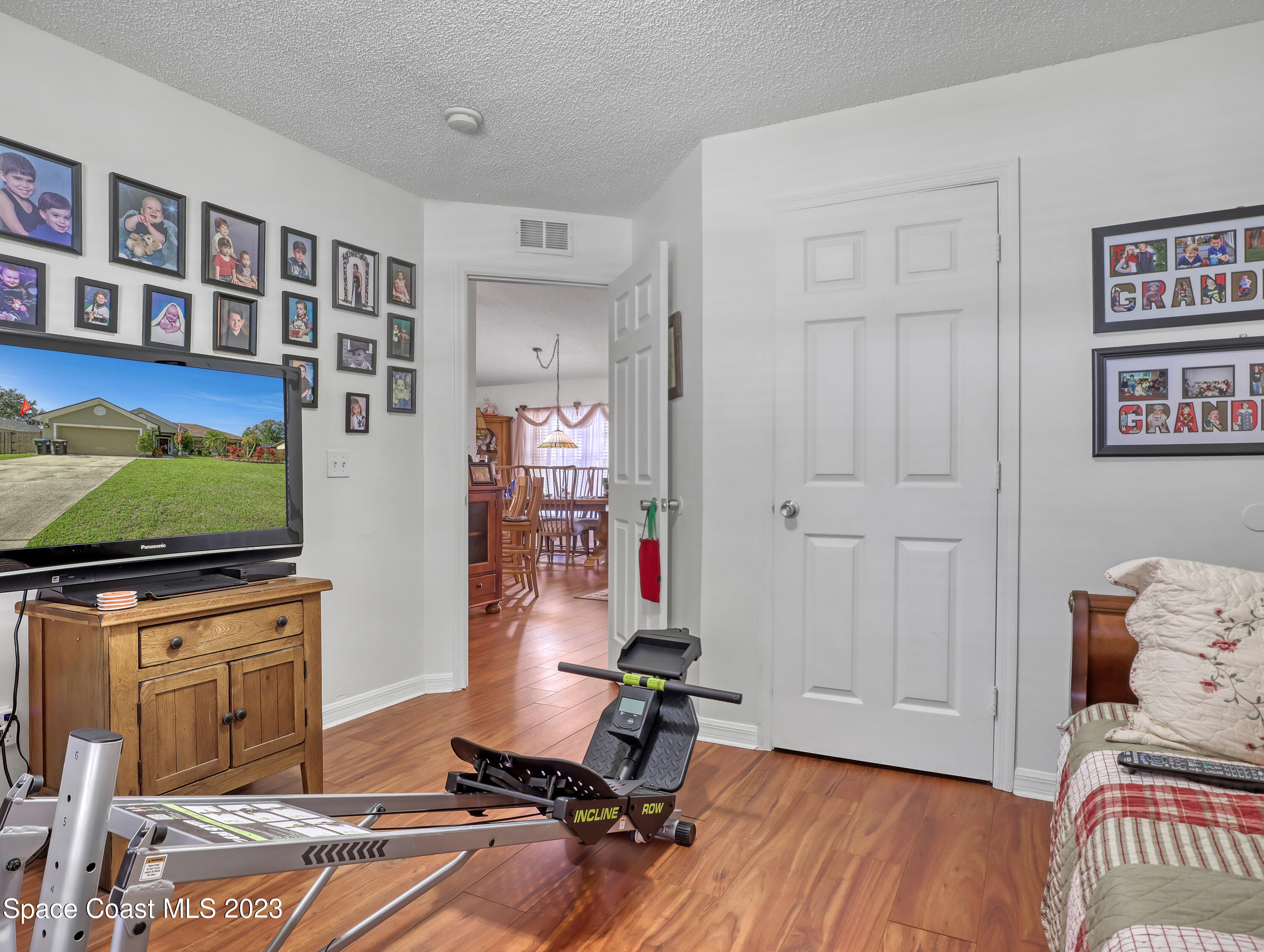 1550 Reed Street Northwest Palm Bay, FL 32907 - Photo 27 of 33 a living room with furniture and a flat screen tv