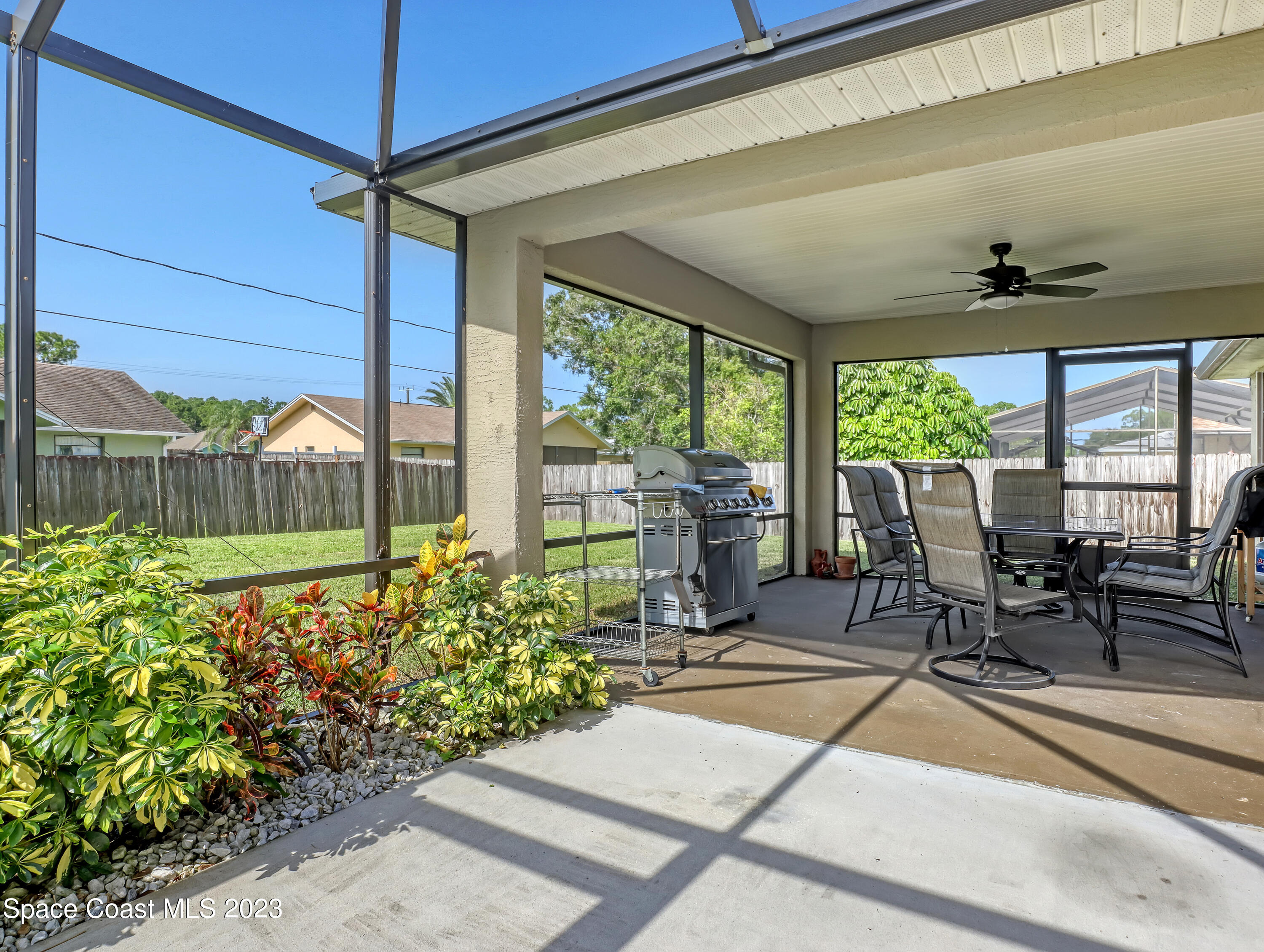 1550 Reed Street Northwest Palm Bay, FL 32907 - Photo 28 of 33 a view of a porch with chairs and backyard