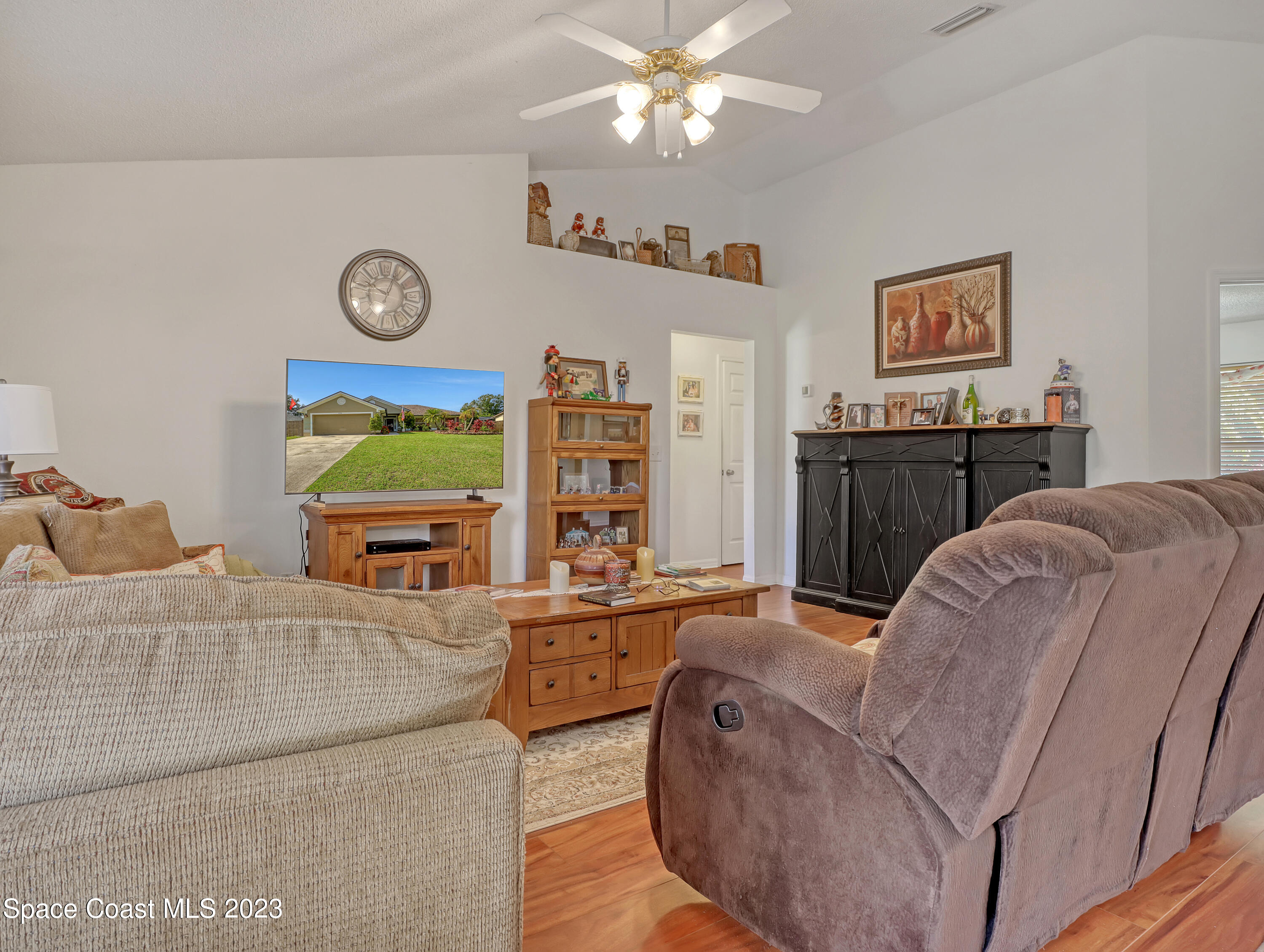 1550 Reed Street Northwest Palm Bay, FL 32907 - Photo 7 of 33 a living room with furniture and a flat screen tv