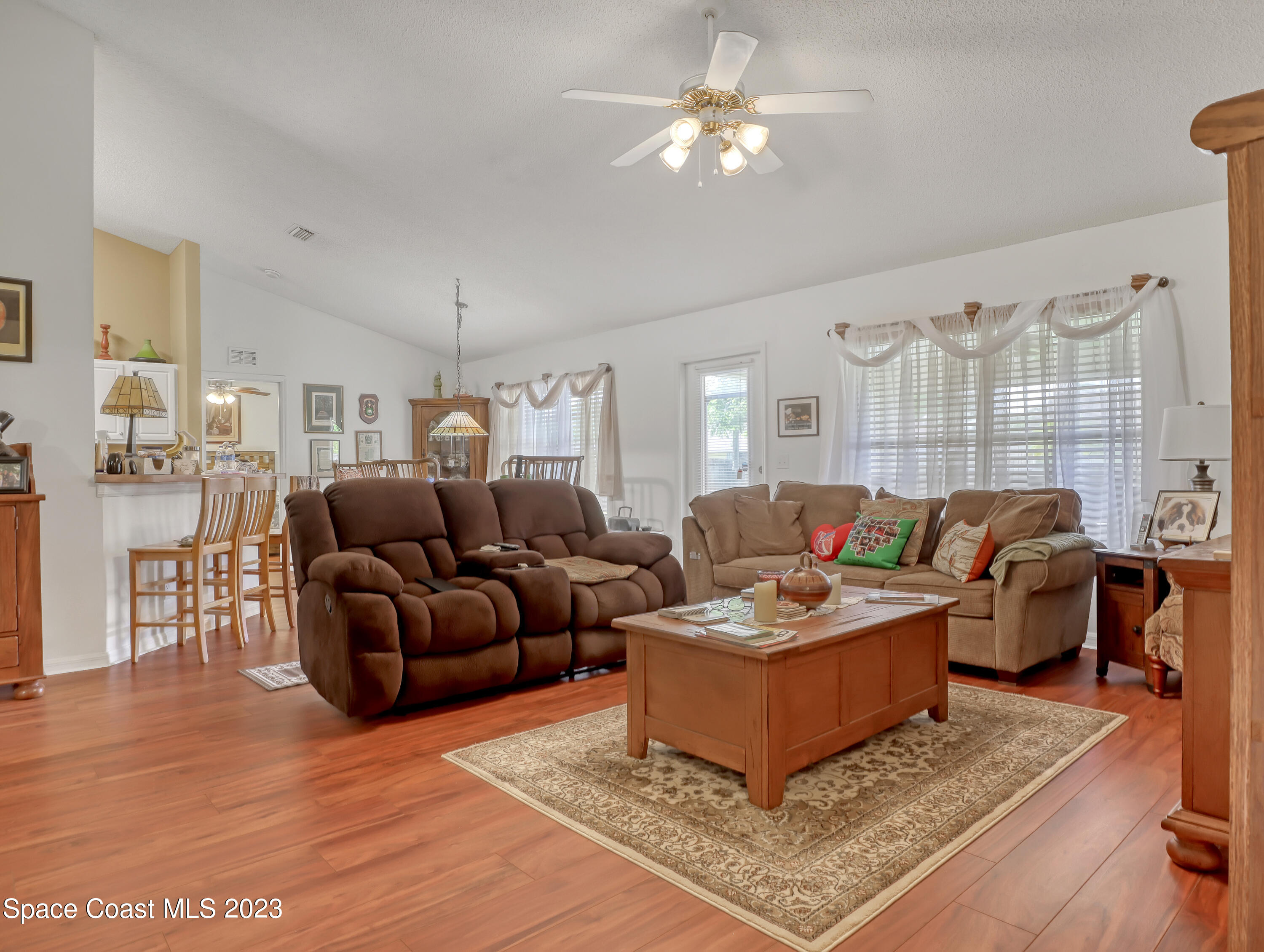 1550 Reed Street Northwest Palm Bay, FL 32907 - Photo 8 of 33 a living room with furniture a rug and a chandelier