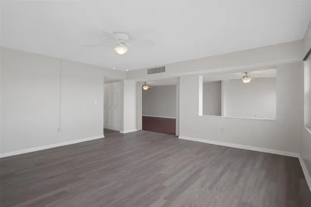 a view of an empty room with wooden floor