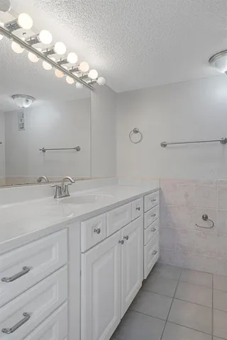 a bathroom with a sink a vanity and a mirror