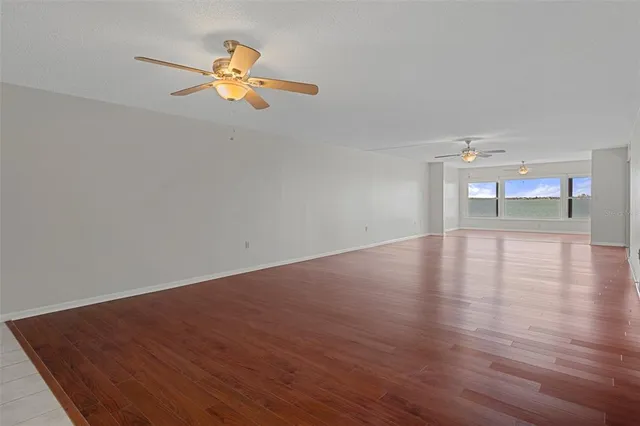 a view of empty room with wooden floor