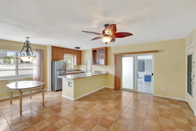 a kitchen with stainless steel appliances granite countertop a refrigerator and a stove