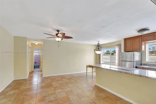 a kitchen with granite countertop a refrigerator and a sink