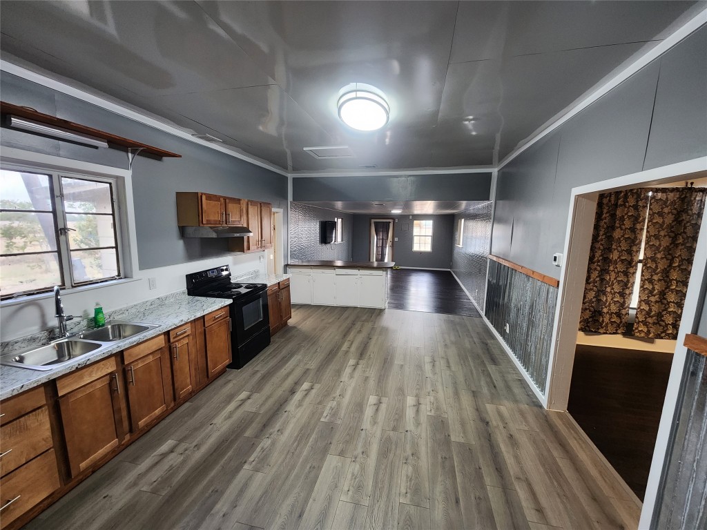 10001 Farm To Market Road 1331 Taylor, TX 76574 - Photo 1 of 10 a large kitchen with wooden floors and stainless steel appliances