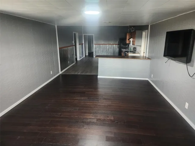 a view of a kitchen with wooden floor and a sink