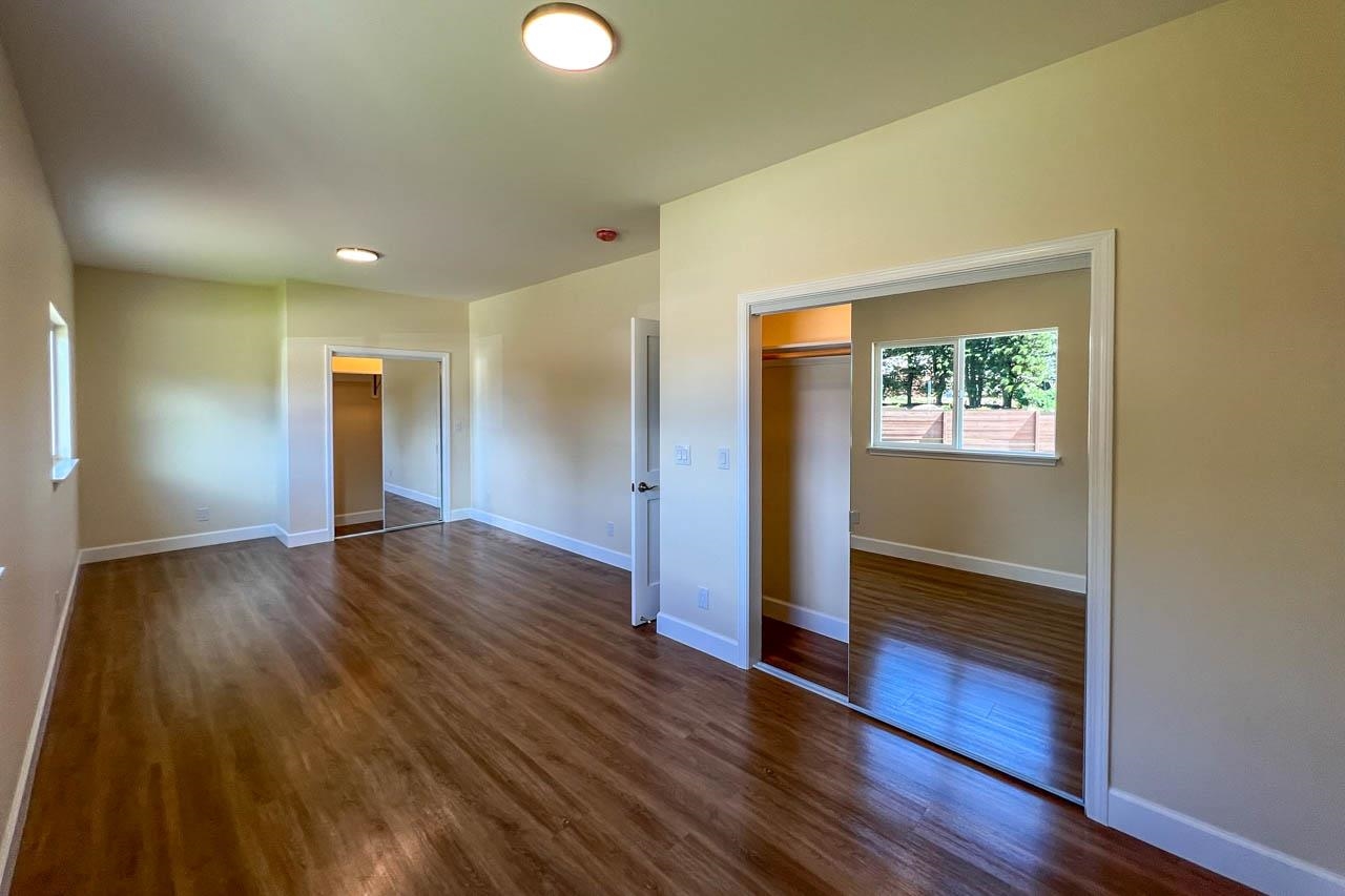 2728 Kaupakalua Road, Unit B Haiku, HI 96708 - Photo 13 of 29 a view of an empty room with wooden floor and a window