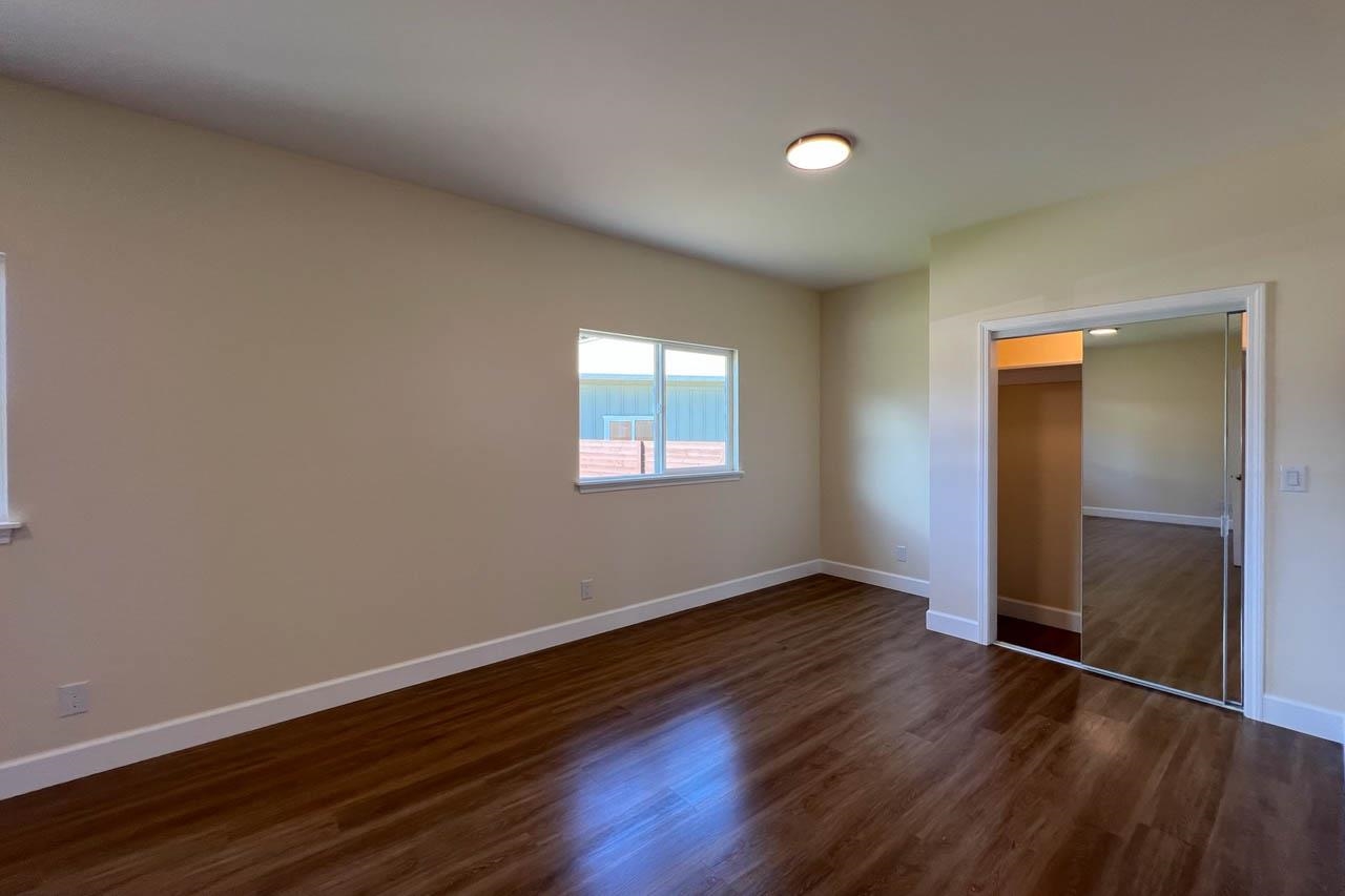 2728 Kaupakalua Road, Unit B Haiku, HI 96708 - Photo 16 of 29 an empty room with wooden floor and windows