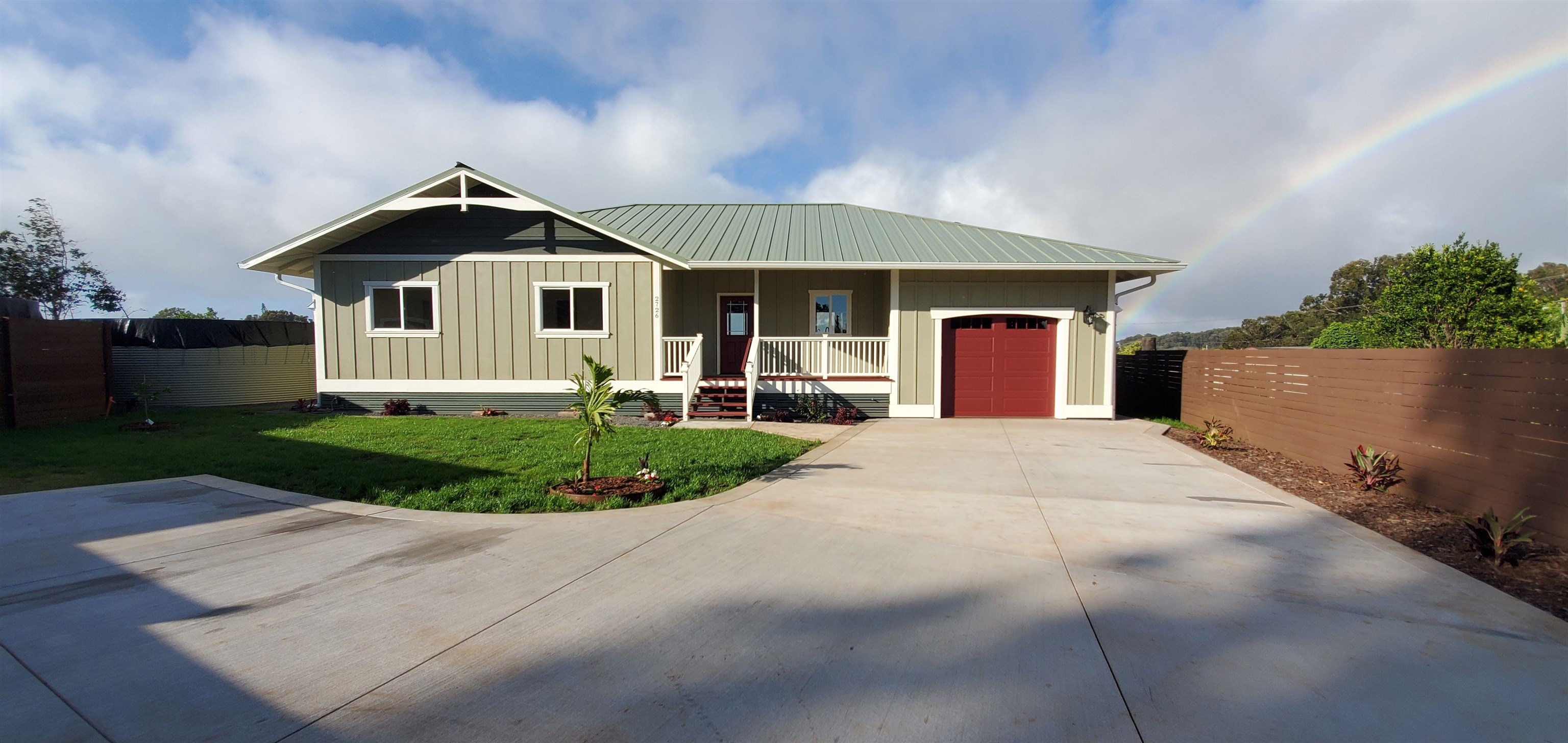 2728 Kaupakalua Road, Unit B Haiku, HI 96708 - Photo 3 of 29 a front view of a house with a yard and garage