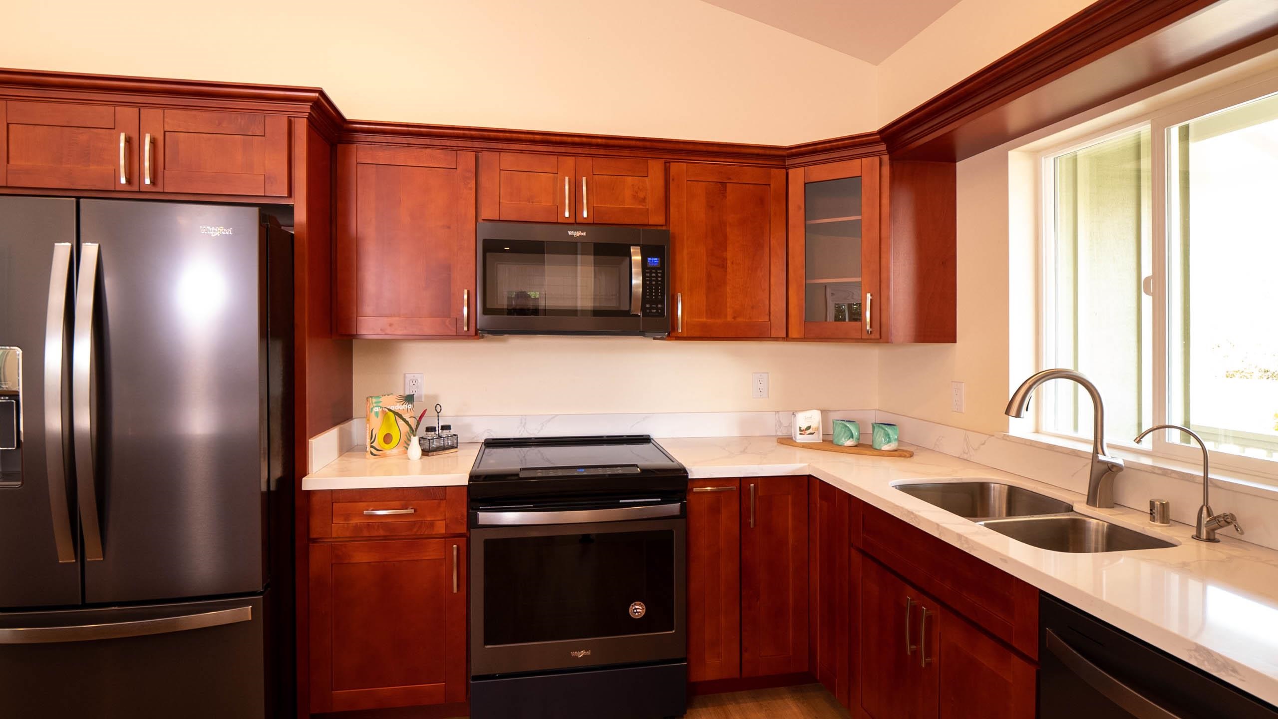 2728 Kaupakalua Road, Unit B Haiku, HI 96708 - Photo 6 of 29 a kitchen with stainless steel appliances a refrigerator sink and microwave