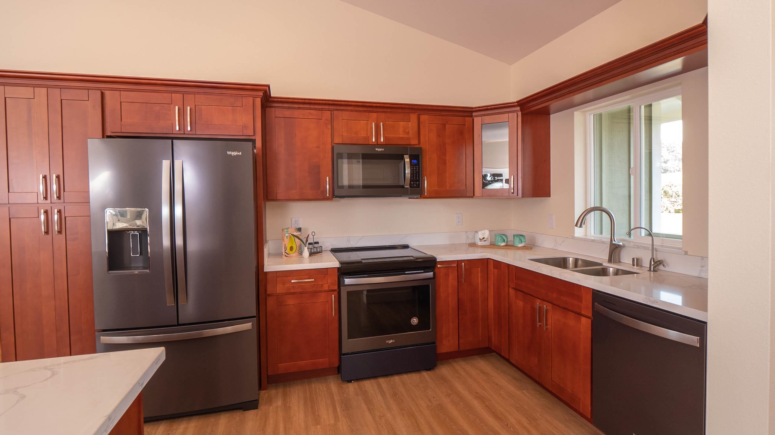 2728 Kaupakalua Road, Unit B Haiku, HI 96708 - Photo 8 of 29 a kitchen with stainless steel appliances granite countertop a refrigerator stove and sink