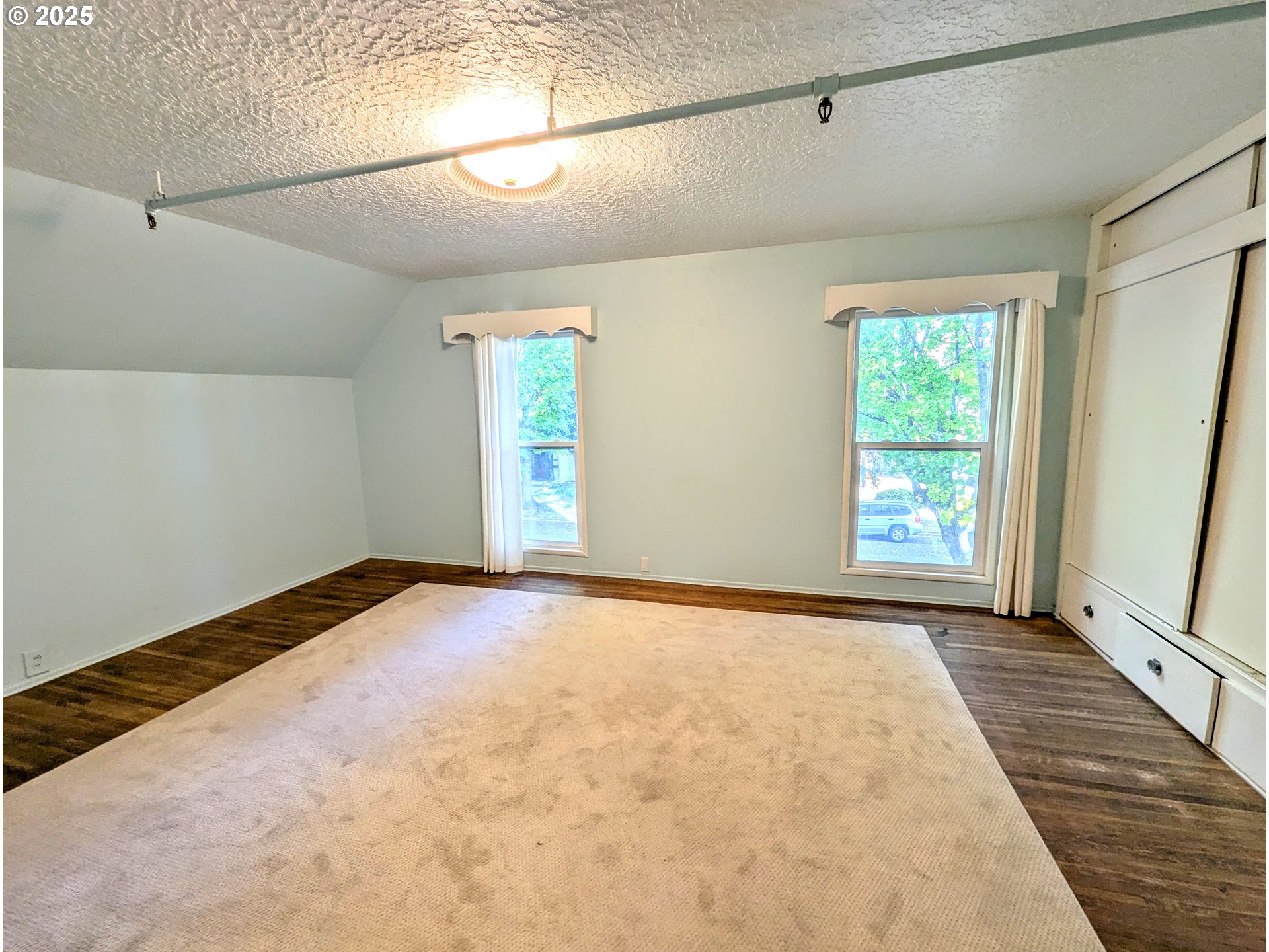 1802 3rd Street La Grande, OR 97850 - Photo 13 of 21 a view of a big room with windows and chandelier fan