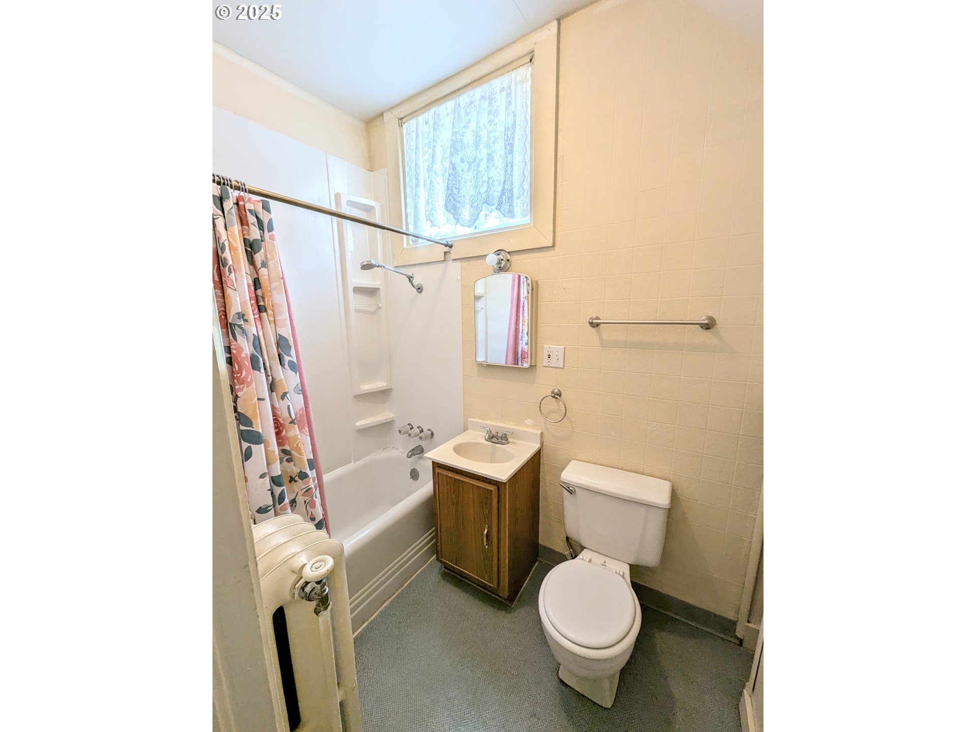 1802 3rd Street La Grande, OR 97850 - Photo 15 of 21 a white toilet sitting next to a bathroom sink and a window
