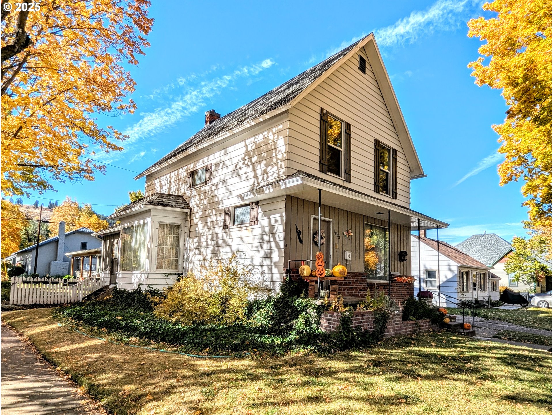 1802 3rd Street La Grande, OR 97850 - Photo 2 of 21 a front view of a house with a yard outdoor seating and covered with trees