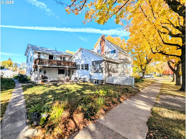 a view of a house with a yard patio and swimming pool