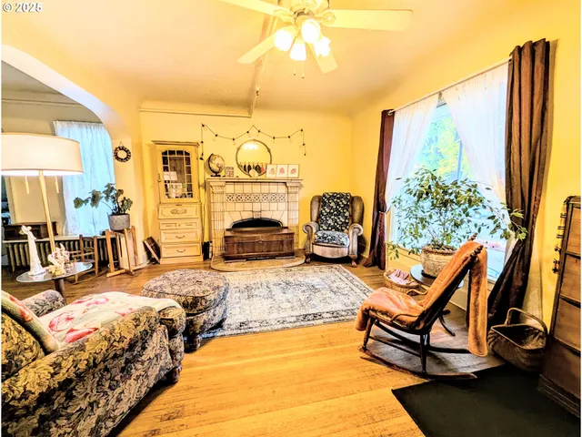 a bedroom with furniture and a large window