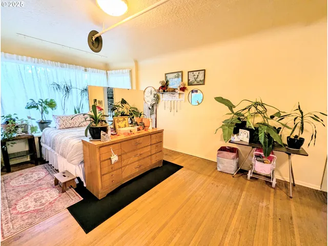 a bed room with furniture and a wooden floor