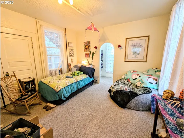 a bedroom with bed and a window