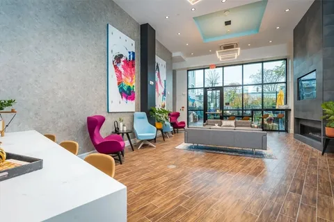 a living room filled with furniture and floor to ceiling window