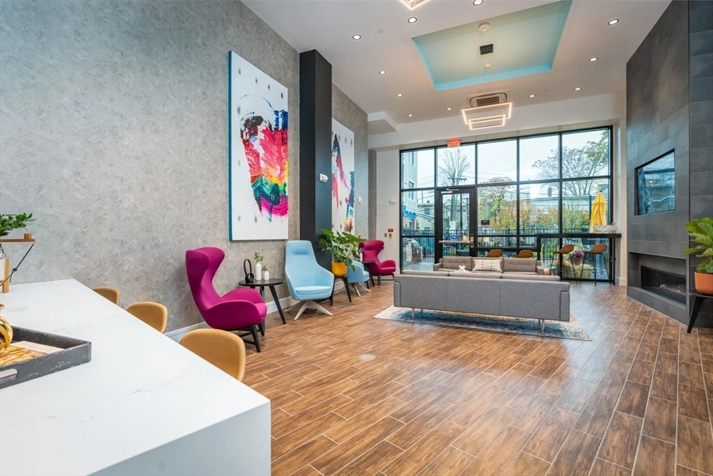 346 Somerville Avenue, Unit 304 Somerville, MA 02143 - Photo 6 of 10 a living room filled with furniture and floor to ceiling window