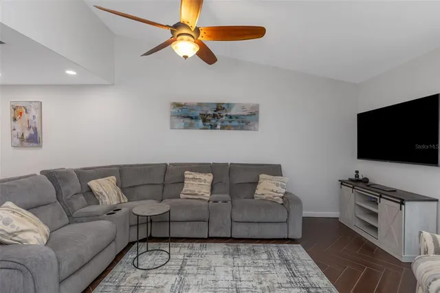 a kitchen with stainless steel appliances granite countertop a sink a stove and a refrigerator