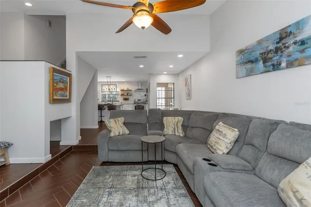 a kitchen with stainless steel appliances a stove a sink dishwasher and a refrigerator with wooden floor