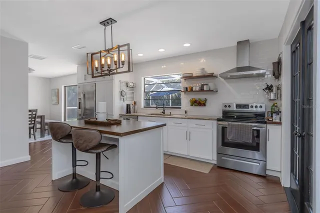 a view of a dining room with furniture wooden floor and chandelier