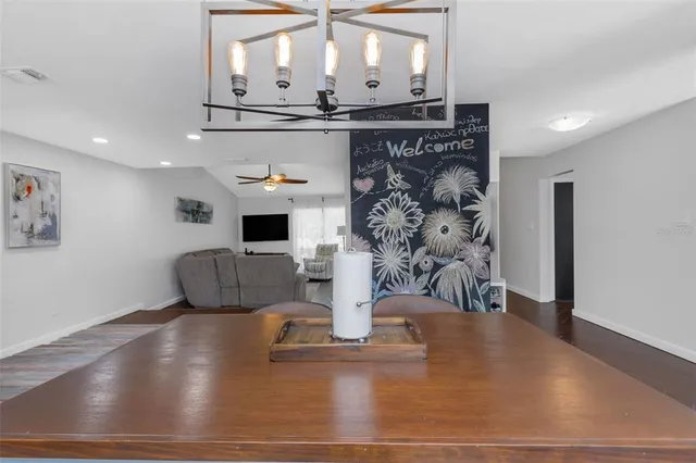 a view of a patio with table and chairs under an umbrella