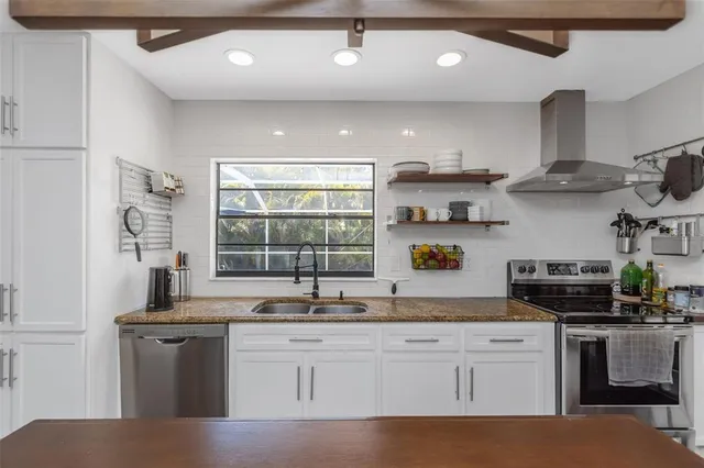 a view of a house with backyard porch and sitting area