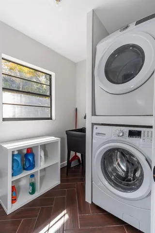 a view of a backyard with swimming pool and sitting area
