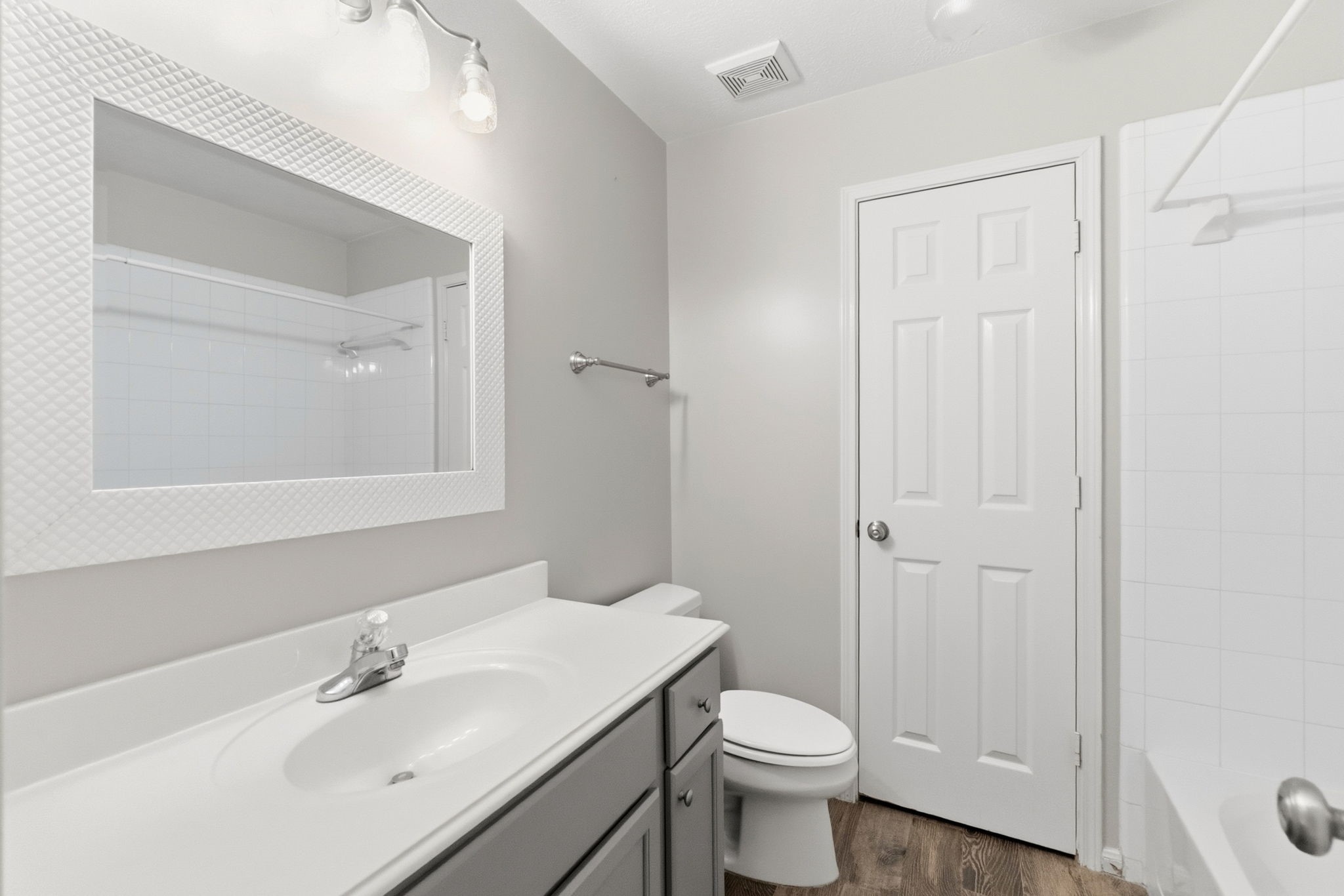 3403 Arromanches Lane Spring, TX 77388 - Photo 33 of 39 Full bathroom upstairs is modern, light and bright with shades of gray and crips white. Quartz vanity, silver fixtures and convenient tub/shower combo complete this bathroom in style.