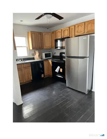 a kitchen with sink refrigerator and cabinets