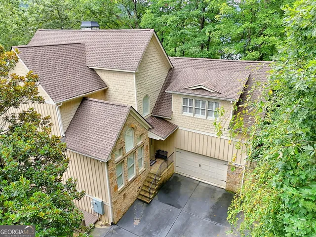 an aerial view of a house with swimming pool and garden
