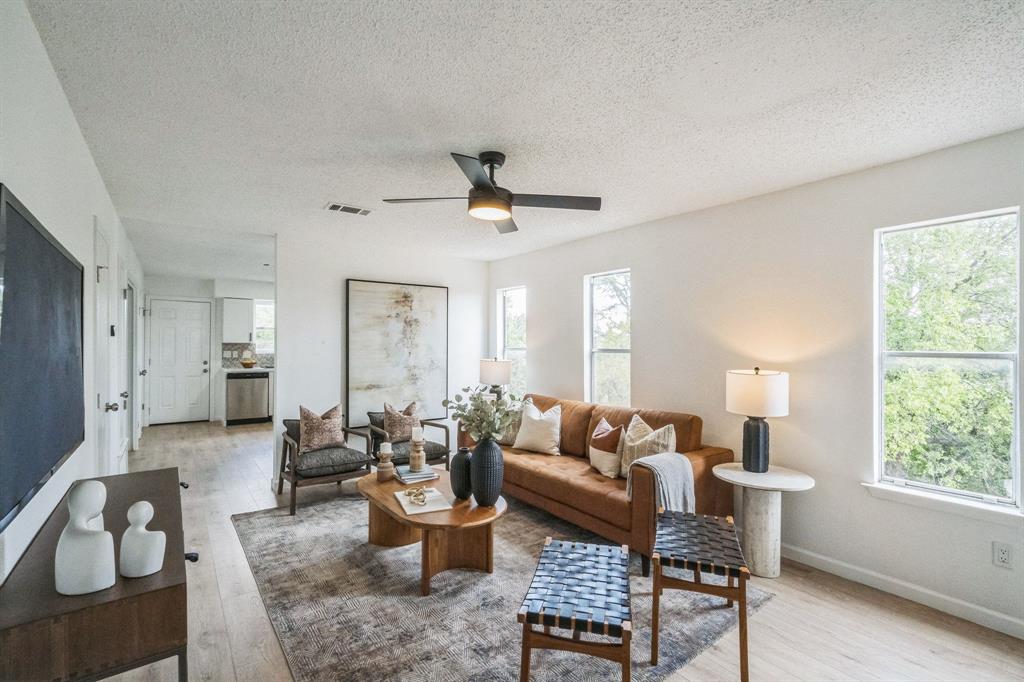 6914 Rifle Bend, Unit A Austin, TX 78736 - Photo 2 of 14 Smooth wood floors flow through this light-filled main living space with neighborhood views.