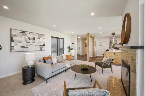 a kitchen with stainless steel appliances kitchen island granite countertop a table and chairs in it