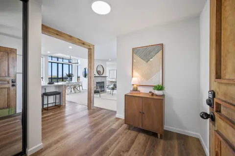 a kitchen with stainless steel appliances a refrigerator sink and white cabinets