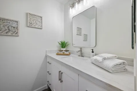 a white toilet sitting next to a bathroom sink
