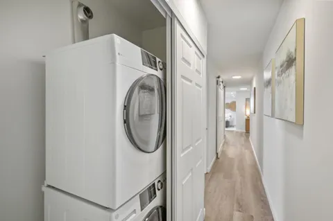 a view of a kitchen with kitchen island a counter space a sink and a refrigerator