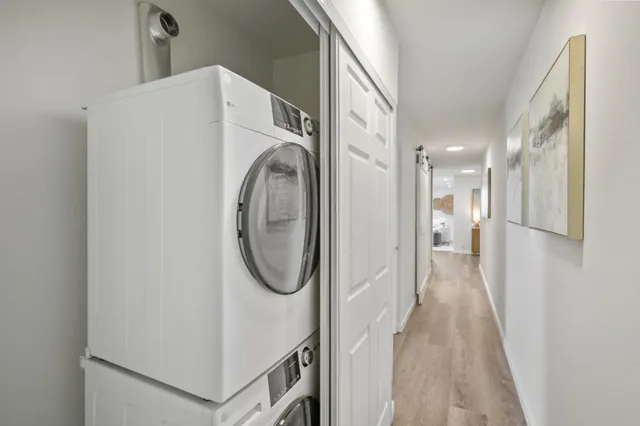 a view of a kitchen with kitchen island a counter space a sink and a refrigerator
