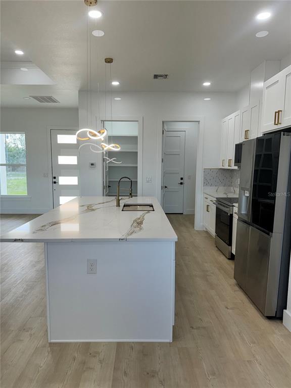 1721 McClellan Road Frostproof, FL 33843 - Photo 12 of 41 a large kitchen with stainless steel appliances a large counter top